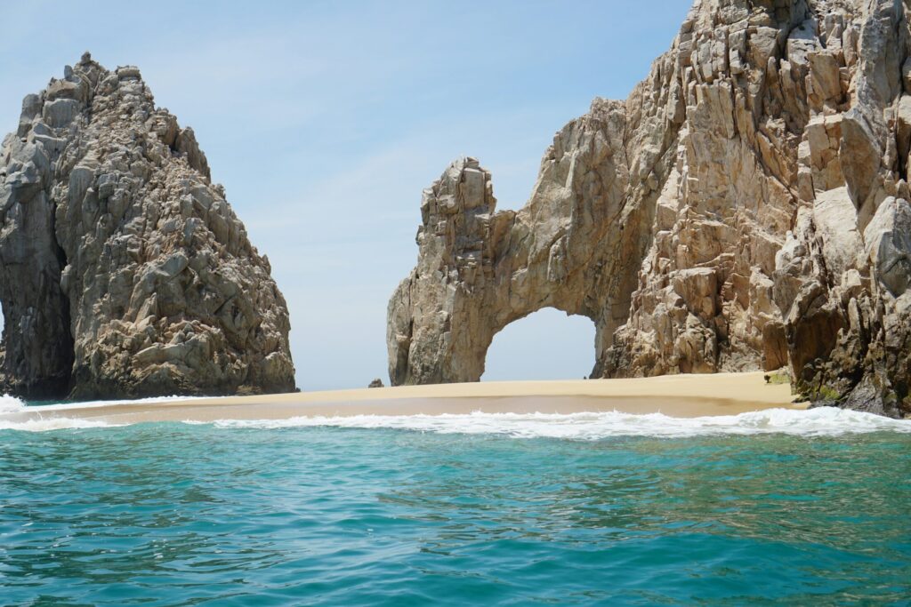 brown rock formation on the sea during daytime
